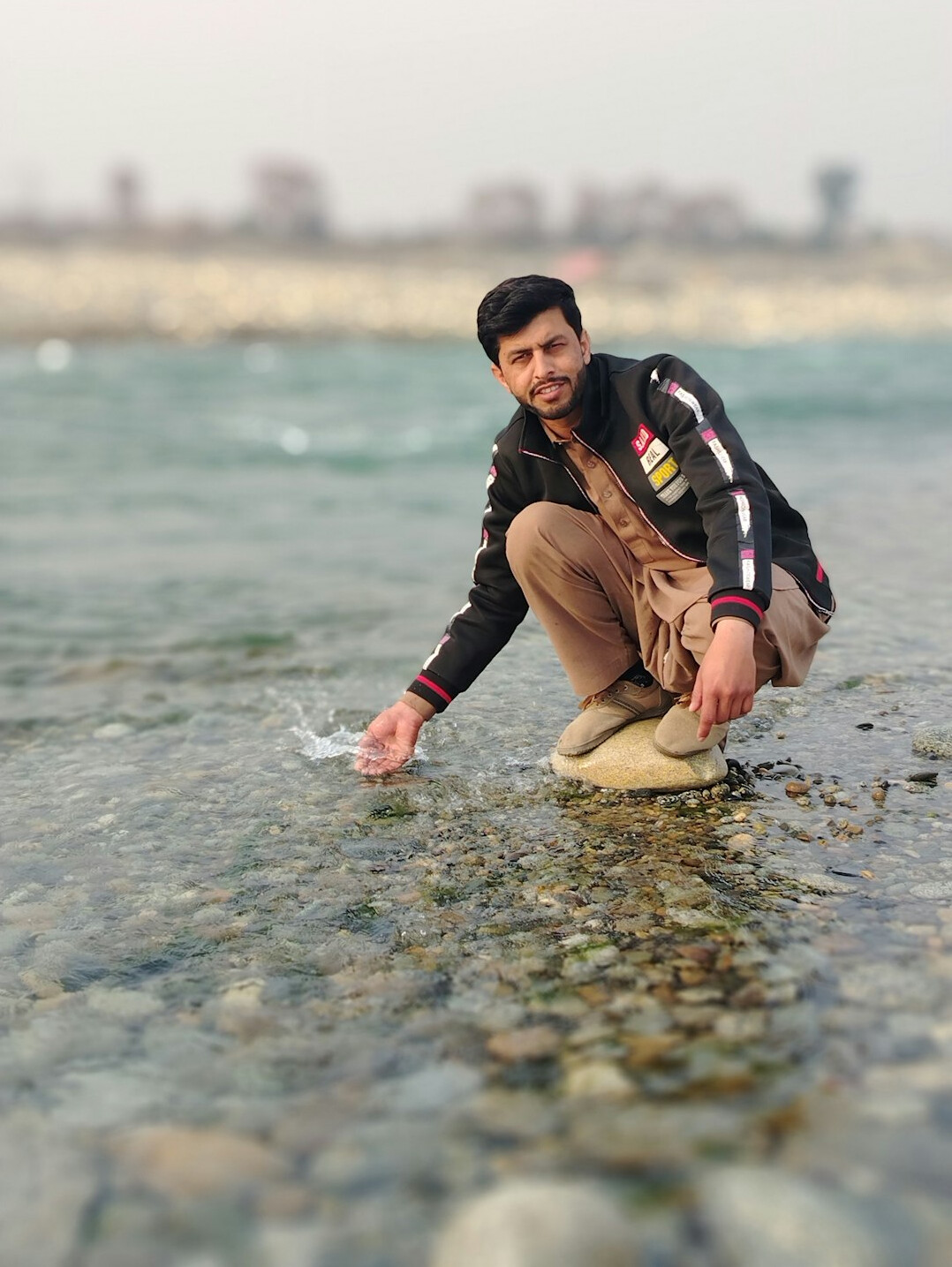 Journalist collecting a river water sample for testing